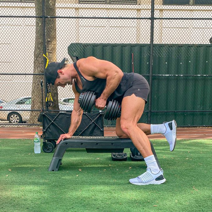 Andrew Morrill weight trains outside.